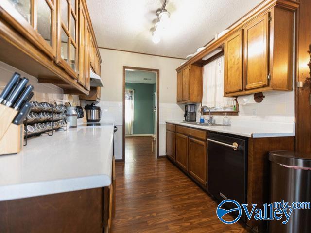 kitchen with sink, dark hardwood / wood-style floors, and black dishwasher