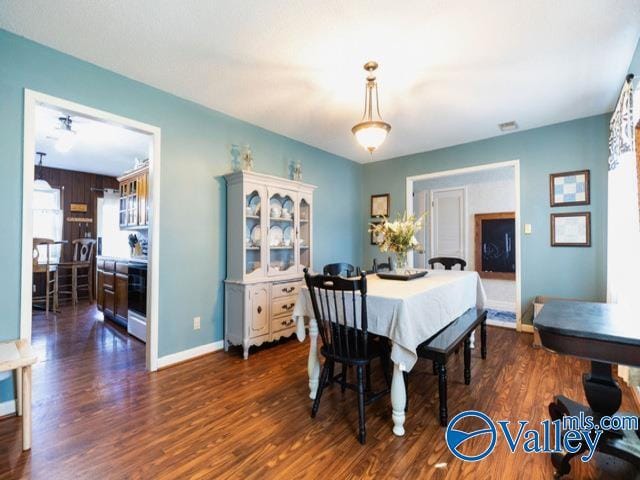 dining space with dark hardwood / wood-style floors