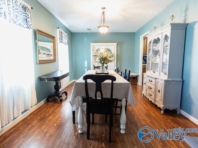 dining area with dark hardwood / wood-style flooring