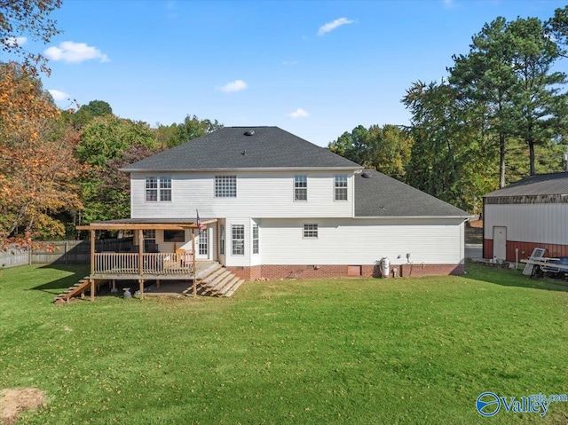 back of house with a deck and a lawn