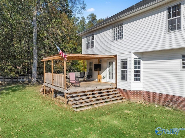 back of property featuring a yard and a wooden deck