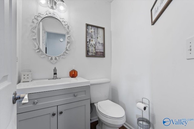 bathroom with toilet and vanity