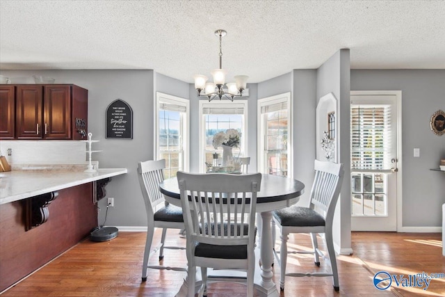 dining room featuring light hardwood / wood-style flooring, a chandelier, and plenty of natural light