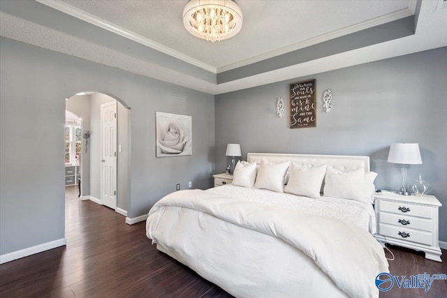 bedroom featuring ornamental molding, a raised ceiling, and dark hardwood / wood-style flooring