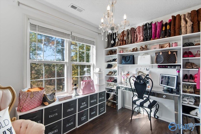 office space featuring an inviting chandelier, a textured ceiling, and dark hardwood / wood-style flooring