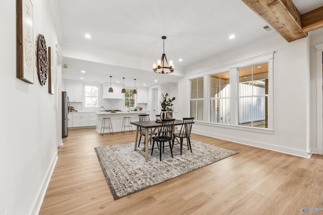 dining area featuring a notable chandelier and light hardwood / wood-style floors