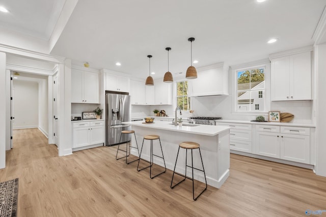 kitchen featuring sink, light hardwood / wood-style floors, stainless steel fridge with ice dispenser, and white cabinets