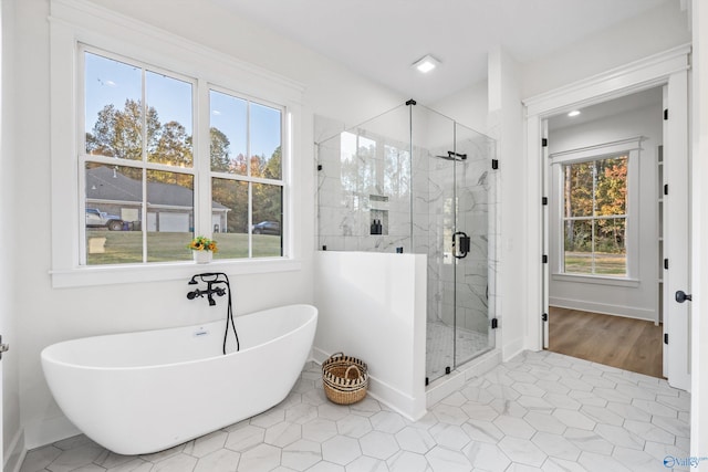 bathroom with separate shower and tub and tile patterned floors