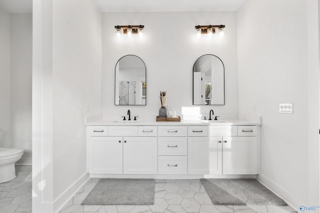 bathroom featuring vanity and toilet