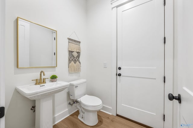 bathroom featuring toilet and hardwood / wood-style flooring