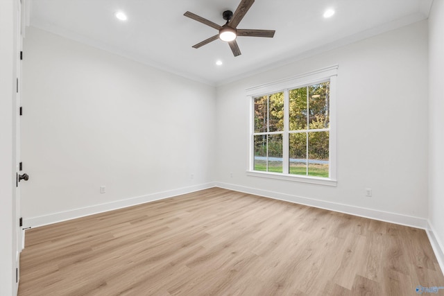 empty room with light hardwood / wood-style floors, ornamental molding, and ceiling fan