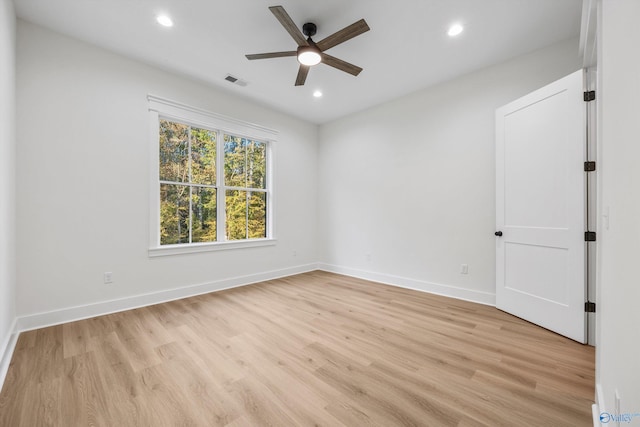 spare room with light hardwood / wood-style floors and ceiling fan