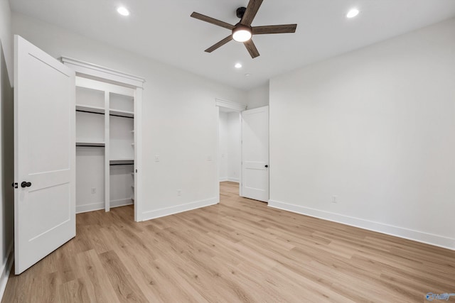 unfurnished bedroom with a closet, light wood-type flooring, and ceiling fan