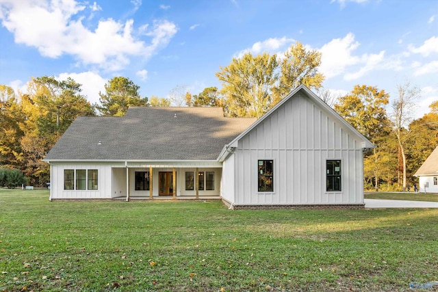 back of property featuring a yard