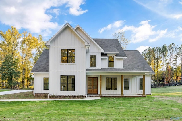 modern farmhouse style home with a porch and a front lawn