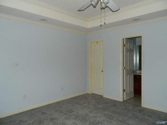 spare room featuring carpet floors, crown molding, a raised ceiling, a ceiling fan, and baseboards