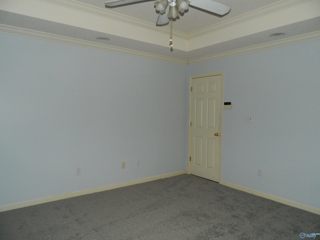 unfurnished room featuring baseboards, a raised ceiling, a ceiling fan, ornamental molding, and carpet floors