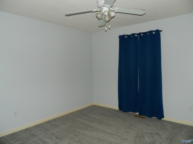 unfurnished room with carpet floors, ceiling fan, baseboards, and a textured ceiling