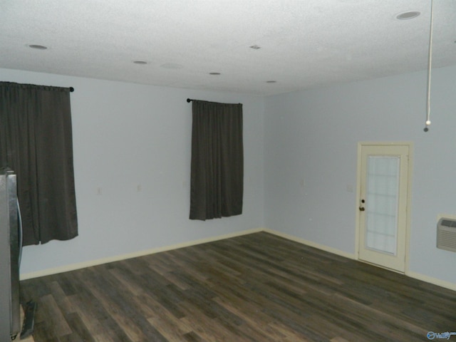 spare room featuring baseboards and wood finished floors