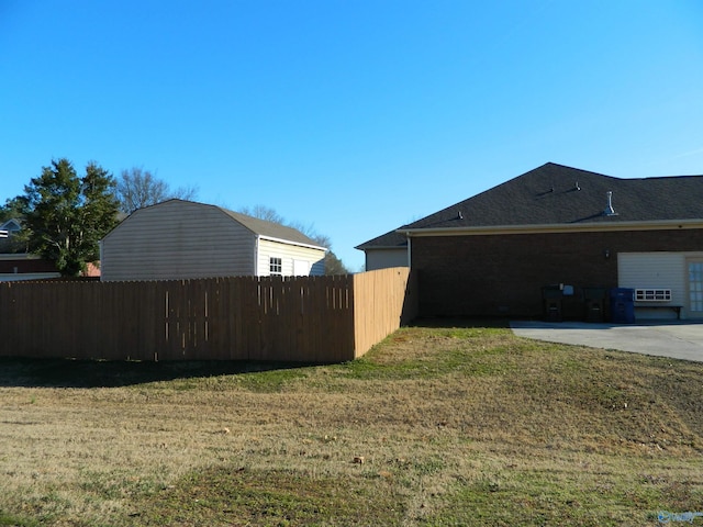 view of property exterior with fence, a lawn, and a patio