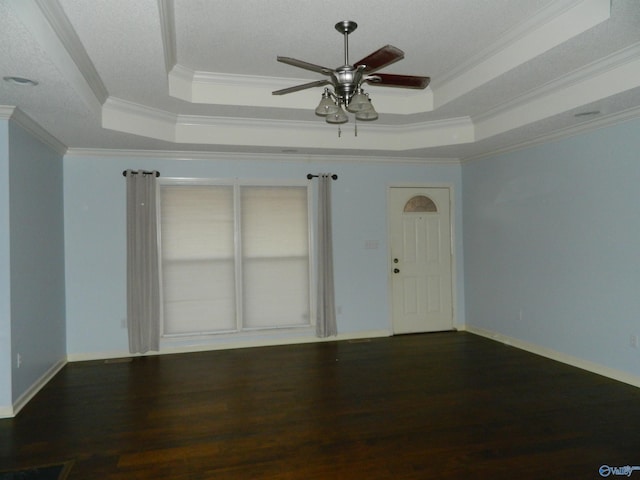 unfurnished room featuring ceiling fan, a raised ceiling, crown molding, and wood finished floors