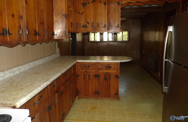 kitchen with white range oven and stainless steel refrigerator