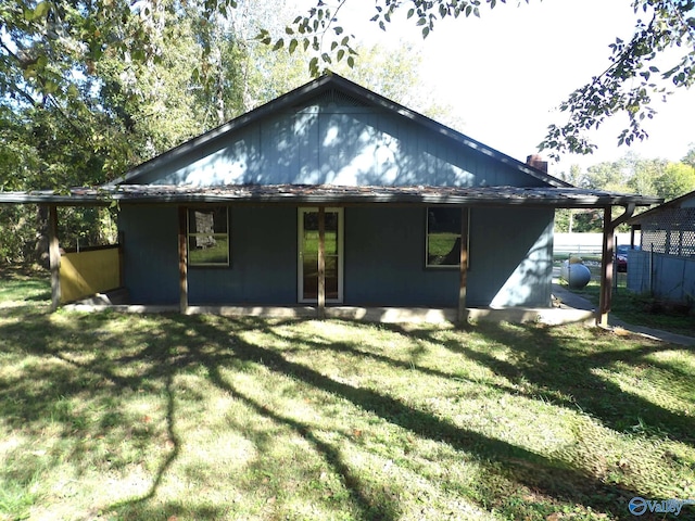 rear view of property with a yard