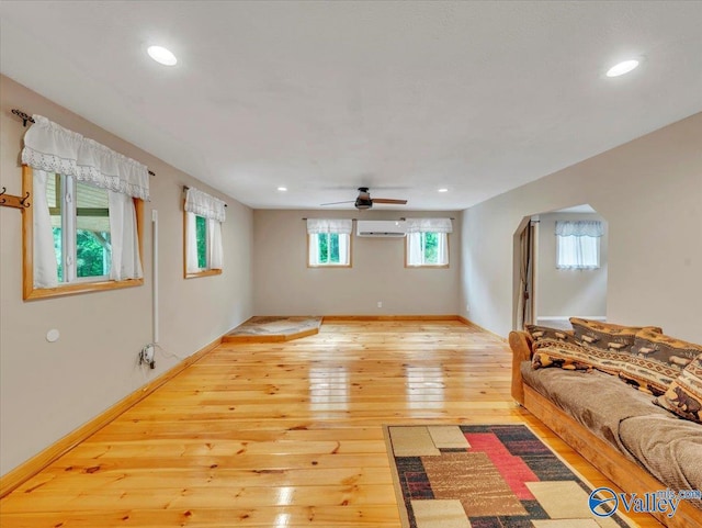 1228 Matt Morrow Rd, Arab, AL 35016 - living room with a wall mounted AC, a ceiling fan, light wood-type flooring, recessed lighting, and arched walkways