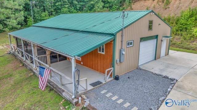1228 Matt Morrow Rd, Arab, AL 35016 - exterior space featuring a detached garage, driveway, and a metal roof