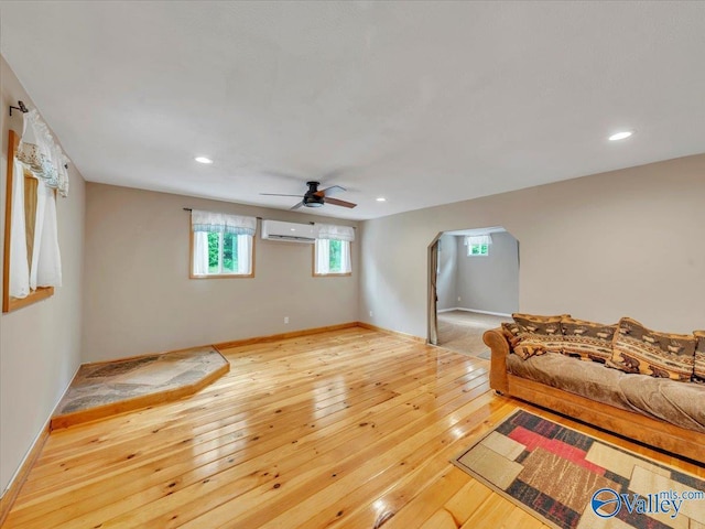 1228 Matt Morrow Rd, Arab, AL 35016 - living room featuring a wall unit AC, ceiling fan, wood-type flooring, arched walkways, and recessed lighting