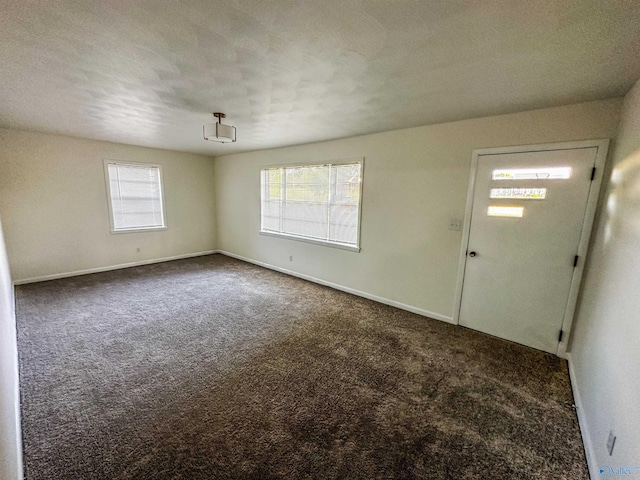 spare room with carpet floors and baseboards