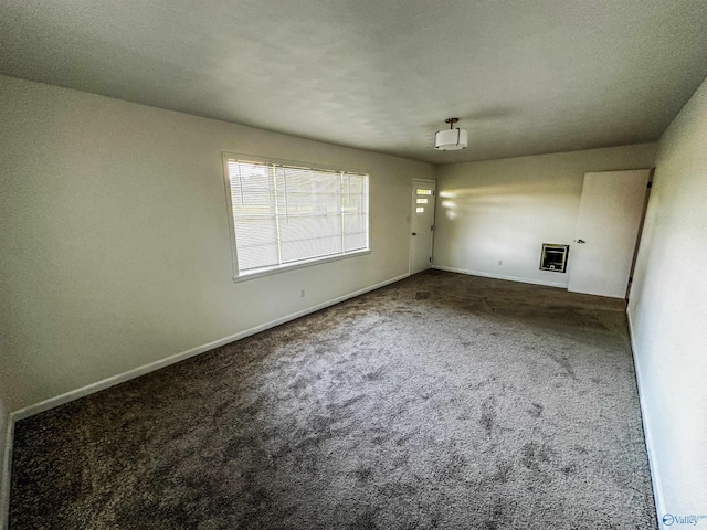 unfurnished room with carpet floors and baseboards