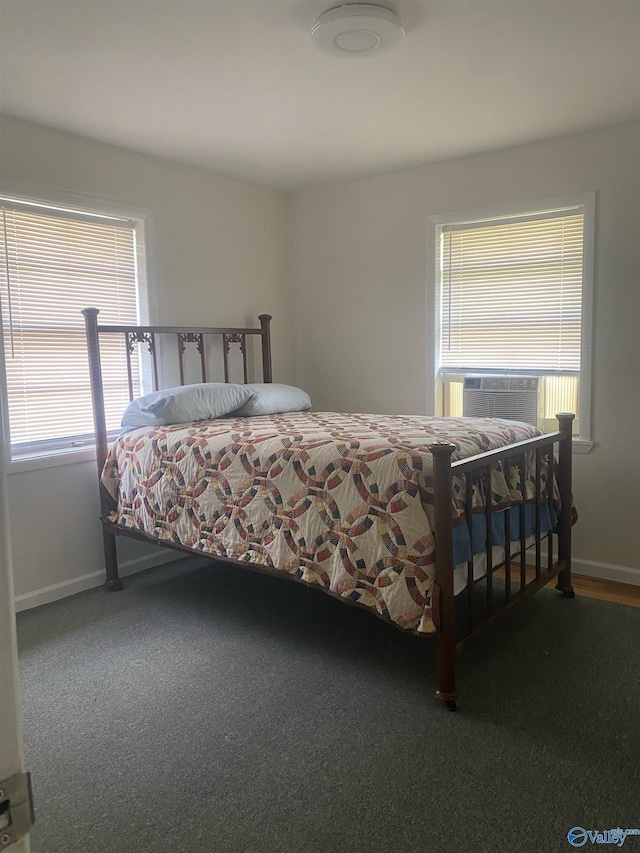 carpeted bedroom featuring cooling unit and baseboards