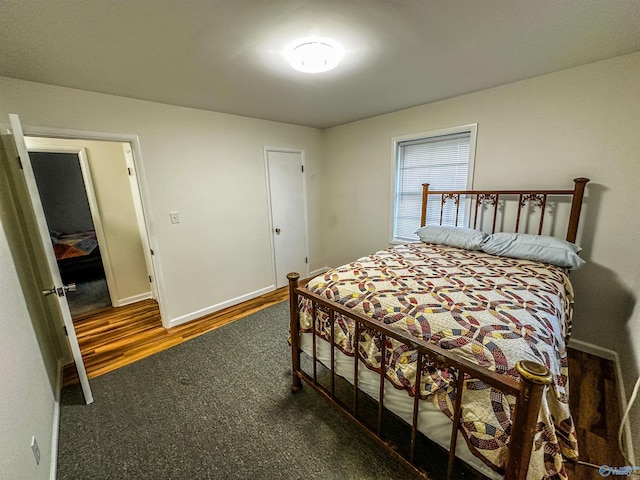 bedroom featuring wood finished floors and baseboards