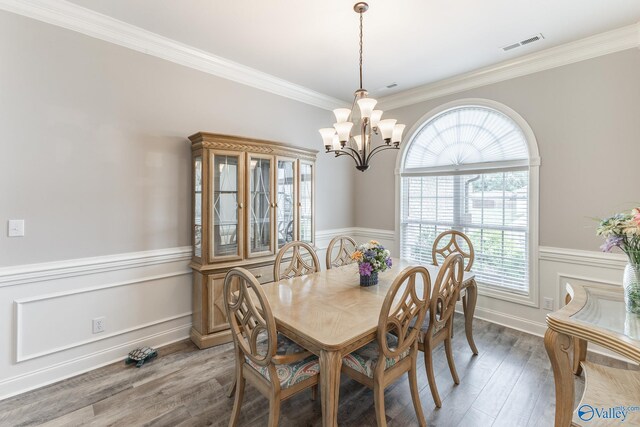 14537 Willow Bend Dr, Athens, AL 35613 - dining room featuring a chandelier, wainscoting, wood finished floors, ornamental molding, and plenty of natural light