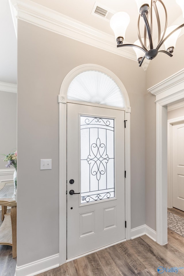 14537 Willow Bend Dr, Athens, AL 35613 - foyer with a chandelier, ornamental molding, wood finished floors, and baseboards