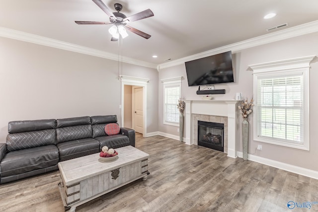 14537 Willow Bend Dr, Athens, AL 35613 - living room featuring ceiling fan, crown molding, a tile fireplace, baseboards, and wood finished floors