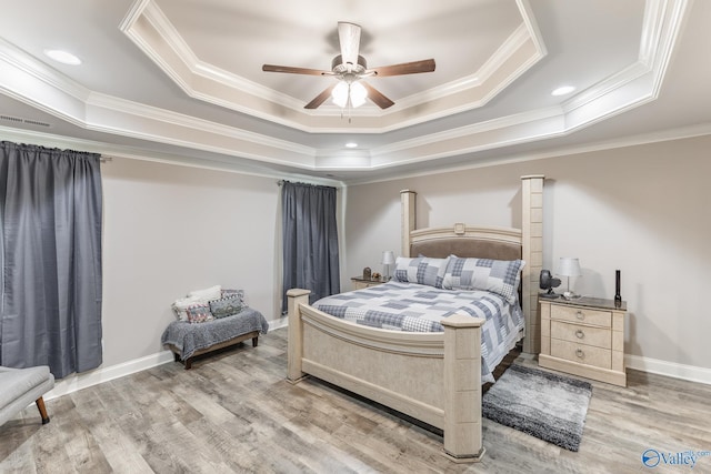 14537 Willow Bend Dr, Athens, AL 35613 - bedroom with a tray ceiling, ornamental molding, wood finished floors, baseboards, and a ceiling fan