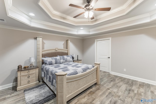 14537 Willow Bend Dr, Athens, AL 35613 - bedroom featuring a tray ceiling, crown molding, light wood-style floors, baseboards, and ceiling fan
