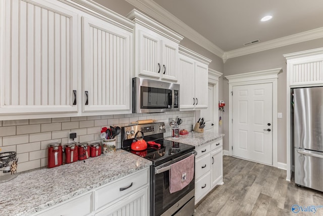 14537 Willow Bend Dr, Athens, AL 35613 - kitchen with stainless steel appliances, ornamental molding, decorative backsplash, light wood finished floors, and light stone counters