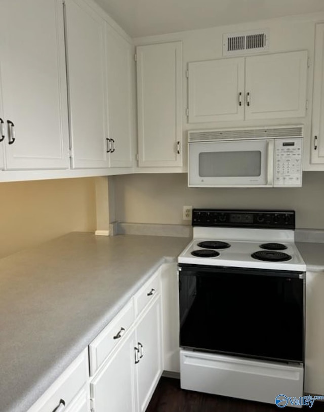 kitchen featuring white appliances, visible vents, white cabinets, and light countertops