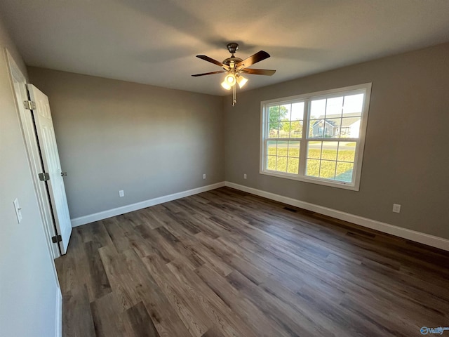 unfurnished room featuring dark hardwood / wood-style floors and ceiling fan