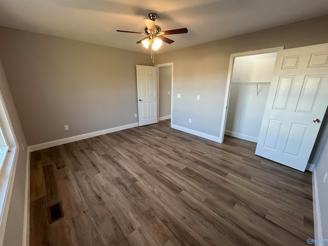 unfurnished bedroom with a closet, ceiling fan, and dark hardwood / wood-style floors