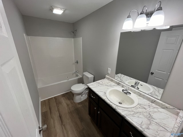 full bathroom with bathtub / shower combination, vanity, hardwood / wood-style flooring, and toilet