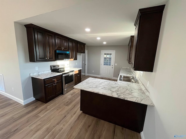 kitchen featuring stainless steel range with electric stovetop, light hardwood / wood-style flooring, sink, and dark brown cabinets