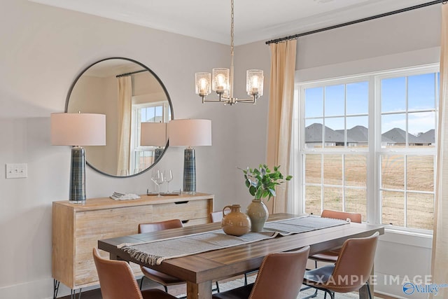 dining area with ornamental molding and a notable chandelier