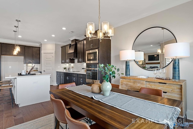 dining room featuring crown molding, dark hardwood / wood-style flooring, and an inviting chandelier