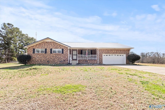 single story home featuring a garage, a front yard, and covered porch