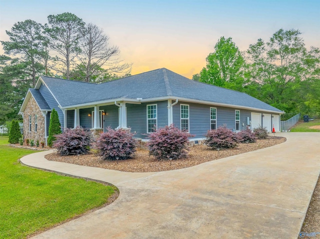 4198 Pilgrims Rest Rd, Southside, AL 35907 - property exterior at dusk with driveway, a lawn, roof with shingles, and covered porch