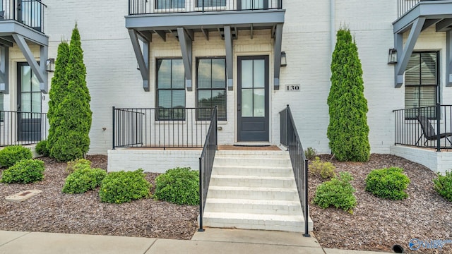 130 Iberville St, Madison, AL 35758 - property entrance featuring a balcony and brick siding
